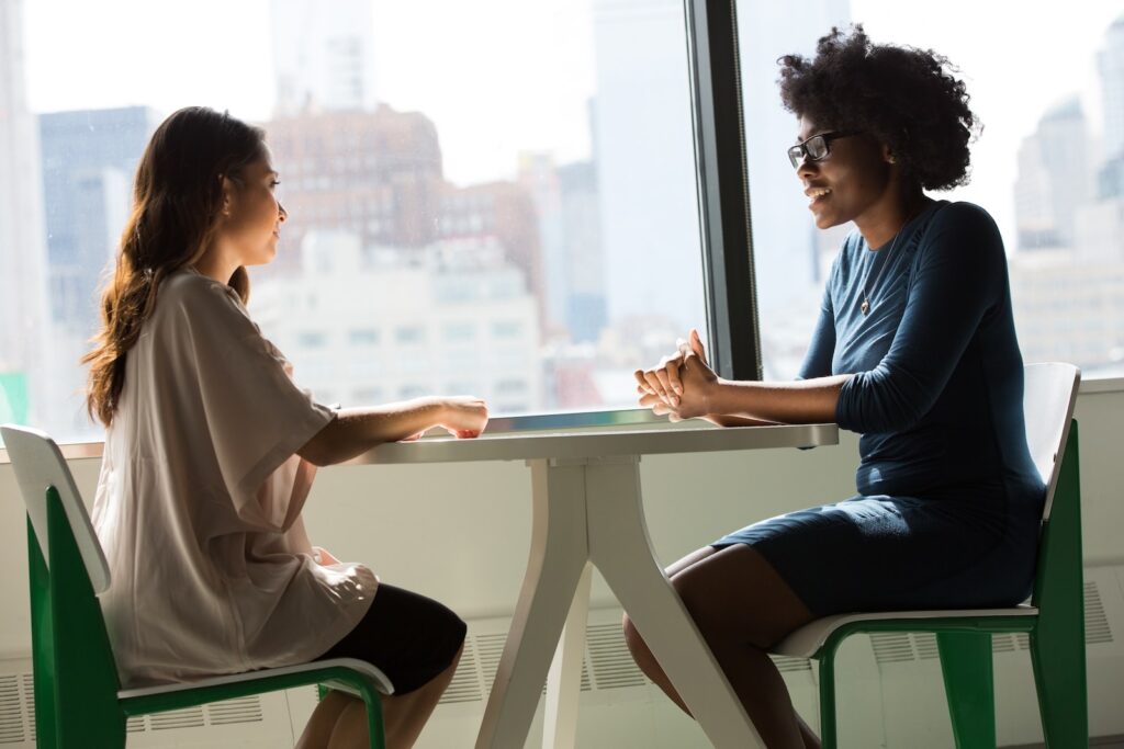 Two women doing a language exchange at a table